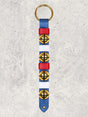 Four solid brass colonial-style bells on a blue leather strap with red & white keepers